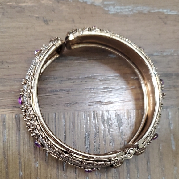 Gold tone Intricate bracelet w/ raised pattern with amethyst cor stones on Hinge - Picture 2 of 5